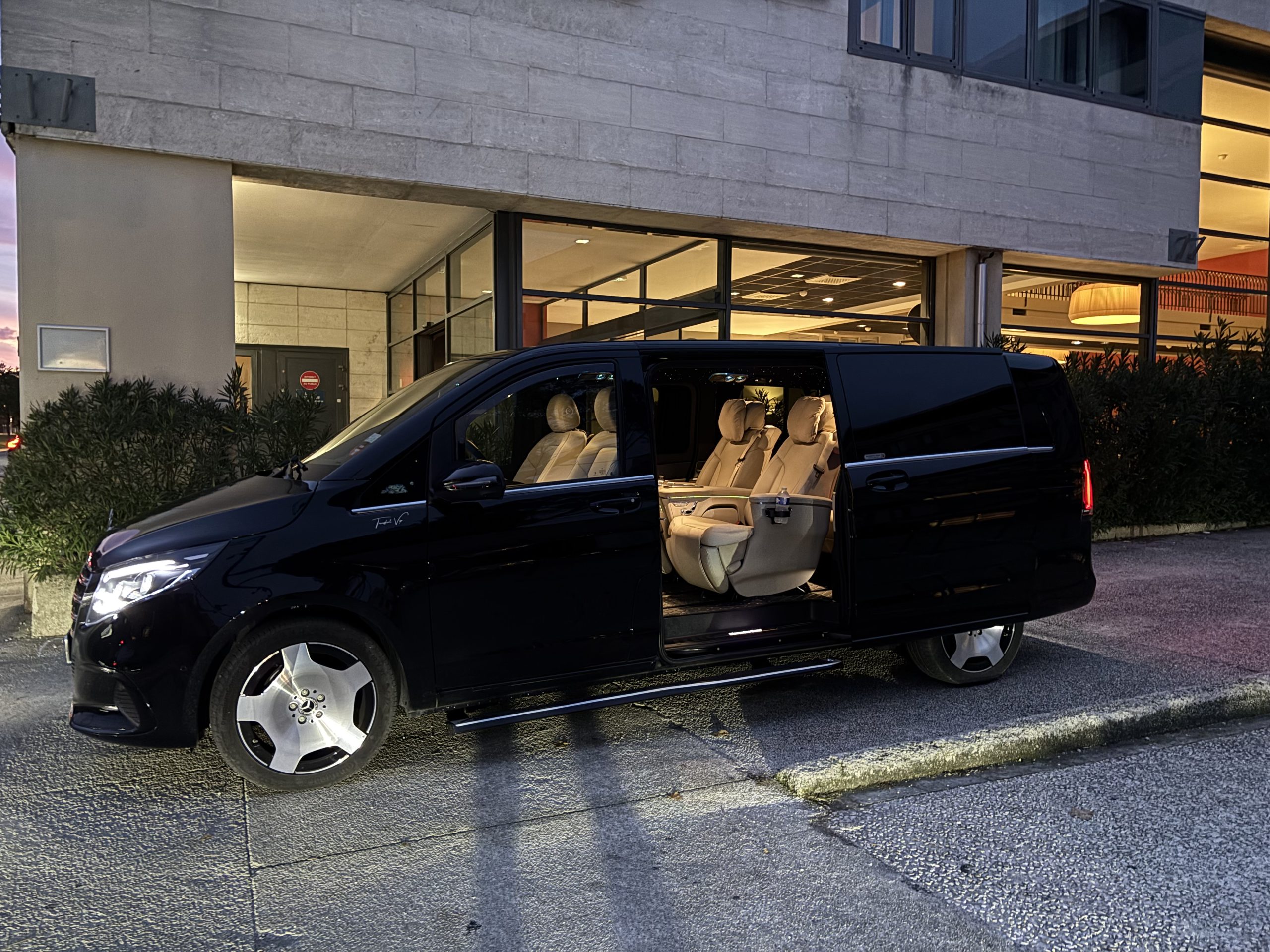 Black Mercedes VIP Class with private driver outside a hotel, transfers to Courchevel